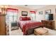 Cozy bedroom with carpeted floors, a plaid comforter, and a mounted TV at 6390 Whispering Clouds Ct, Las Vegas, NV 89141