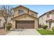 Two-story home with a well-maintained lawn and a two-car garage at 6390 Whispering Clouds Ct, Las Vegas, NV 89141