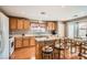 Functional kitchen with an island, adjacent to a cozy dining area and a patio at 6390 Whispering Clouds Ct, Las Vegas, NV 89141