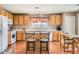 Bright and airy kitchen with wood cabinets and a breakfast bar at 6390 Whispering Clouds Ct, Las Vegas, NV 89141