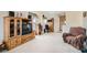 Open-concept living area featuring an entertainment center and plush seating at 6390 Whispering Clouds Ct, Las Vegas, NV 89141