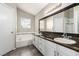 Bathroom with dual sinks, granite countertops, vanity, and soaking tub at 6428 Yarmouth Dr, Las Vegas, NV 89108