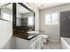 Bathroom featuring granite countertops, a dark backsplash, and ample natural light at 6428 Yarmouth Dr, Las Vegas, NV 89108