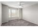 Bright bedroom features neutral walls, plush carpeting, and a ceiling fan for added comfort at 6428 Yarmouth Dr, Las Vegas, NV 89108