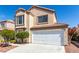 Two-story home with desert landscaping, a two-car garage, and a neutral color scheme at 6428 Yarmouth Dr, Las Vegas, NV 89108
