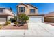 Two-story home with desert landscaping, a two-car garage, and a neutral color scheme at 6428 Yarmouth Dr, Las Vegas, NV 89108