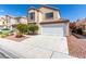 Two-story home with desert landscaping, a two-car garage, and a neutral color scheme at 6428 Yarmouth Dr, Las Vegas, NV 89108