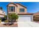 Two-story home with desert landscaping, a two-car garage, and a neutral color scheme at 6428 Yarmouth Dr, Las Vegas, NV 89108