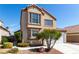 Two-story home with desert landscaping, a two-car garage, and a neutral color scheme at 6428 Yarmouth Dr, Las Vegas, NV 89108