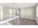 Spacious loft area with neutral walls and staircase at 6428 Yarmouth Dr, Las Vegas, NV 89108