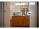 Bathroom with wood cabinets, faucet, mirror, and lighting at 684 Whispering Palms Dr, Las Vegas, NV 89123