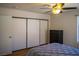 Bedroom featuring a ceiling fan and ample storage with sliding closet doors at 684 Whispering Palms Dr, Las Vegas, NV 89123