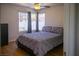 Comfortable bedroom with wood floors, large windows, and a ceiling fan at 684 Whispering Palms Dr, Las Vegas, NV 89123