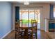 Bright dining area with wood table and chairs, overlooking the backyard at 684 Whispering Palms Dr, Las Vegas, NV 89123