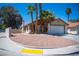 Landscaped front yard featuring palm trees and xeriscaping, paired with a charming home exterior at 684 Whispering Palms Dr, Las Vegas, NV 89123