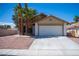 Charming single-story home with a two-car garage and desert landscaping at 684 Whispering Palms Dr, Las Vegas, NV 89123