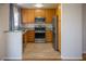 Functional kitchen with wood cabinets and stainless steel appliances at 684 Whispering Palms Dr, Las Vegas, NV 89123