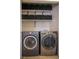 Laundry room with front load washer and dryer with storage at 684 Whispering Palms Dr, Las Vegas, NV 89123