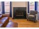 Comfortable living area with a marble fireplace and a plush armchair at 684 Whispering Palms Dr, Las Vegas, NV 89123