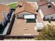 Aerial view of a backyard with gravel landscaping, covered patio, and detached storage shed at 7268 Wichita Ct, Las Vegas, NV 89119