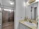 Compact bathroom features tile flooring, a glass-enclosed shower, and a large mirror above the sink at 7268 Wichita Ct, Las Vegas, NV 89119