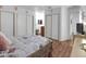 Spacious bedroom with wood floors, sliding closet doors, and neutral decor at 7268 Wichita Ct, Las Vegas, NV 89119