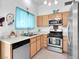 Charming kitchen with stainless steel appliances and a bright, cheerful window at 7268 Wichita Ct, Las Vegas, NV 89119