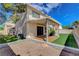 Home's backyard features an artificial turf lawn and covered patio at 7817 Safari Ln, Las Vegas, NV 89129