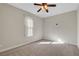 A cozy bedroom with a ceiling fan and a large window at 7817 Safari Ln, Las Vegas, NV 89129