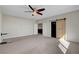 Large bedroom featuring neutral carpeting, a ceiling fan, a sliding barn door, and ample natural light at 7817 Safari Ln, Las Vegas, NV 89129