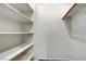 Walk-in closet featuring white shelving and hanging rods for ample storage at 7817 Safari Ln, Las Vegas, NV 89129