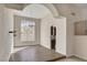 Bright dining area with wood-look flooring, a large window, and an archway leading to the kitchen for easy access at 7817 Safari Ln, Las Vegas, NV 89129