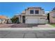 This two-story house has a three-car garage and beige-colored exterior at 7817 Safari Ln, Las Vegas, NV 89129