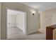 Inviting hallway leading to a carpeted bedroom with neutral tones and stylish light fixture at 7817 Safari Ln, Las Vegas, NV 89129