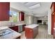 Modern kitchen boasts stainless steel appliances, granite countertops, and an island with open access to the living room at 7817 Safari Ln, Las Vegas, NV 89129