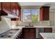 Updated kitchen features granite countertops, stainless steel appliances, and view to backyard at 7817 Safari Ln, Las Vegas, NV 89129