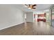 Spacious living room featuring tile floors, ceiling fan, and an open floor plan at 7817 Safari Ln, Las Vegas, NV 89129