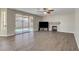 Spacious living room features wood-look tile flooring, a fireplace, and sliding glass doors to the backyard at 7817 Safari Ln, Las Vegas, NV 89129