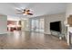 Open-concept living area showcases tile floors, fireplace, ceiling fan, and sliding glass doors to the patio at 7817 Safari Ln, Las Vegas, NV 89129