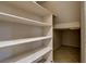 Walk-in pantry with multiple shelves and tile flooring, offering ample storage space at 7817 Safari Ln, Las Vegas, NV 89129