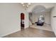 Open recreation room features wood-look tile flooring, recessed lighting, and archways leading to other areas of the house at 7817 Safari Ln, Las Vegas, NV 89129