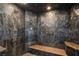 Luxurious shower showcasing intricate stonework, multiple shower heads, and a built-in bench at 7817 Safari Ln, Las Vegas, NV 89129