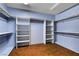 Spacious walk-in closet featuring blue walls, built-in white shelves, and ample storage space at 7817 Safari Ln, Las Vegas, NV 89129