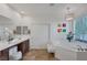 Well-lit bathroom with tub, shower, and contemporary design elements at 7872 Regency Park St, Las Vegas, NV 89149