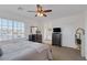 Bright bedroom with large windows, a ceiling fan, and stylish furniture at 7872 Regency Park St, Las Vegas, NV 89149