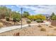 Landscaped community area with walking path and mature trees at 7872 Regency Park St, Las Vegas, NV 89149