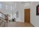 Bright foyer showcases a grand staircase, tile flooring, and a stylish front entrance at 7872 Regency Park St, Las Vegas, NV 89149