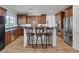 Modern kitchen featuring stainless steel appliances, granite countertops, and a convenient island with seating at 7872 Regency Park St, Las Vegas, NV 89149