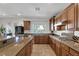 Stylish kitchen with stainless steel appliances, granite countertops, and light brown cabinetry at 7872 Regency Park St, Las Vegas, NV 89149