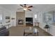 Cozy living room features a decorative fireplace and large windows with natural light at 7872 Regency Park St, Las Vegas, NV 89149